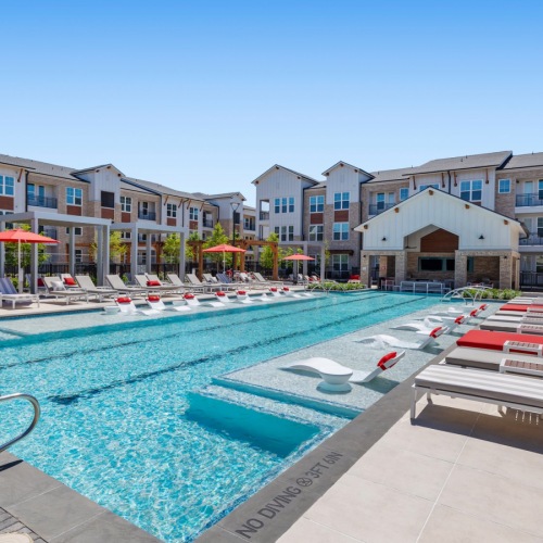 Resort-style swimming pool with lounge seating