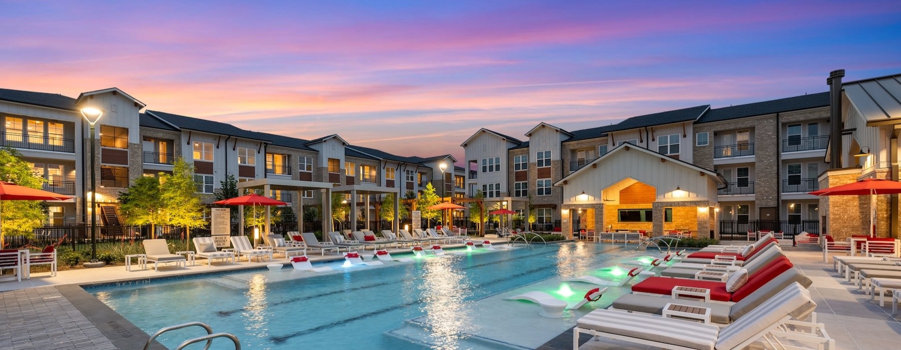 resort style pool with seating and a building behind